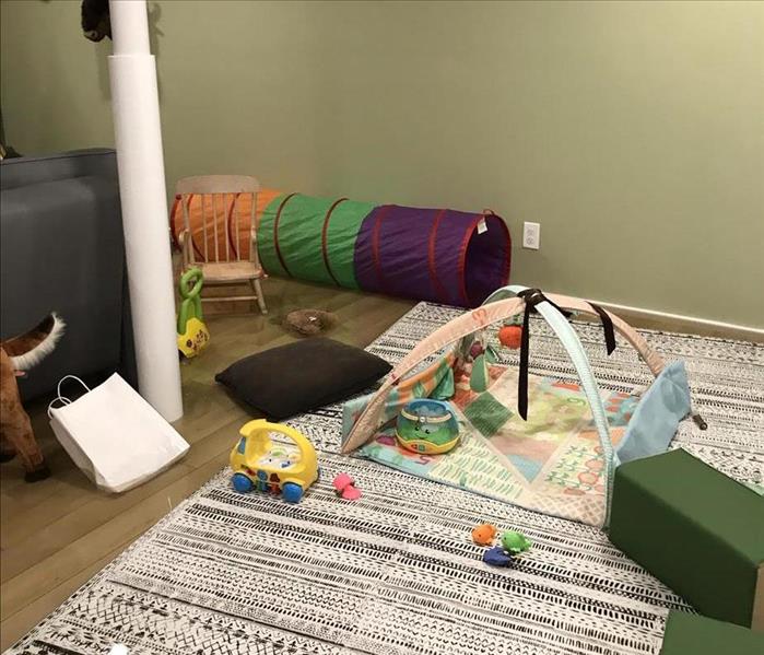 Flooded Playroom with aprox. 5 inches of water with floating playmat and toys