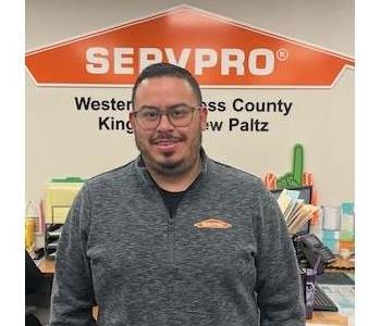 A photo of a smiling male employee wearing glasses and a SERVPRO shirt.