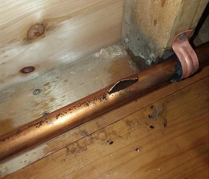 Busted heating pipe in house that caused water damage.